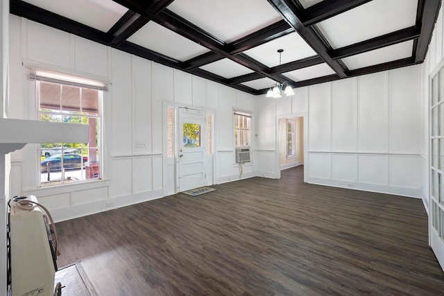 interior space with dark hardwood / wood-style floors, beamed ceiling, coffered ceiling, and an inviting chandelier