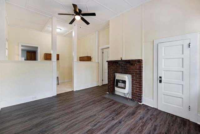 unfurnished living room with heating unit, dark hardwood / wood-style flooring, and ceiling fan