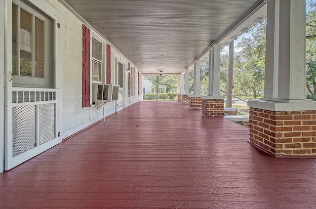 wooden terrace featuring cooling unit and covered porch