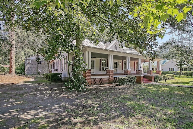 view of front of property with covered porch and a front yard