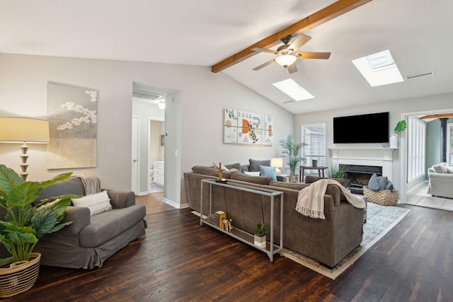 living room with dark wood-type flooring, ceiling fan, and vaulted ceiling with beams