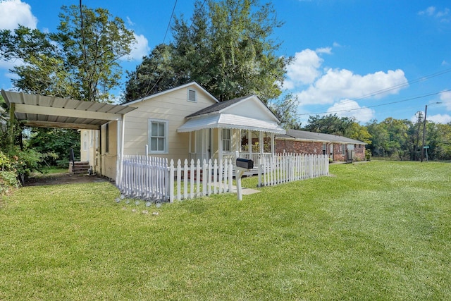 view of front of house with a front yard and a carport