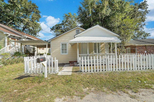 view of front of property with a front yard and a porch