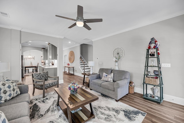 1173 Triple Crown Ct, Mount Pleasant, SC 29429 - living room with stairs, light wood-type flooring, arched walkways, ceiling fan, and visible vents