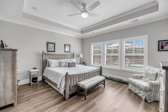 1173 Triple Crown Ct, Mount Pleasant, SC 29429 - bedroom featuring baseboards, a tray ceiling, light wood-style floors, and visible vents