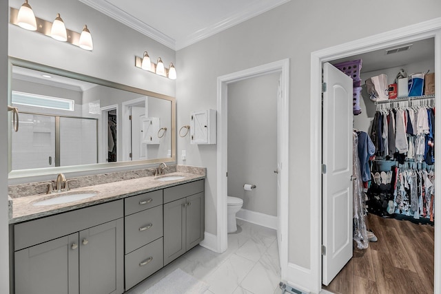 1173 Triple Crown Ct, Mount Pleasant, SC 29429 - bathroom featuring a walk in closet, visible vents, ornamental molding, and a sink
