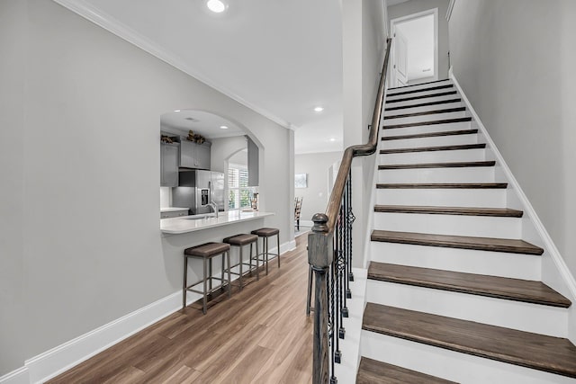 1173 Triple Crown Ct, Mount Pleasant, SC 29429 - stairway with baseboards, ornamental molding, wood finished floors, recessed lighting, and arched walkways