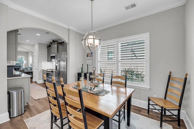 1173 Triple Crown Ct, Mount Pleasant, SC 29429 - dining area with an inviting chandelier, wood finished floors, arched walkways, and visible vents