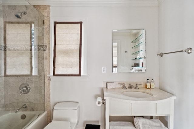 full bathroom featuring crown molding, tiled shower / bath, and toilet