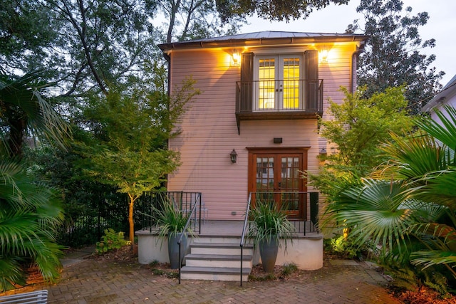 view of front facade with french doors and a balcony