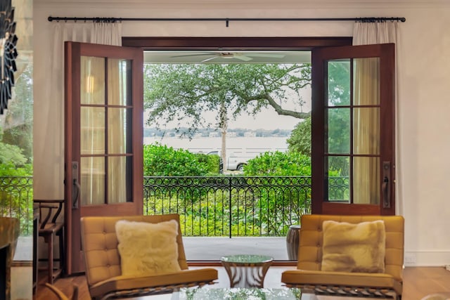 doorway to outside featuring a water view and ceiling fan