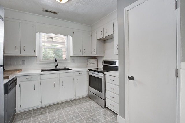 110 Terry Ave, Summerville, SC 29485 - kitchen with stainless steel appliances, a sink, a textured ceiling, decorative backsplash, and light countertops