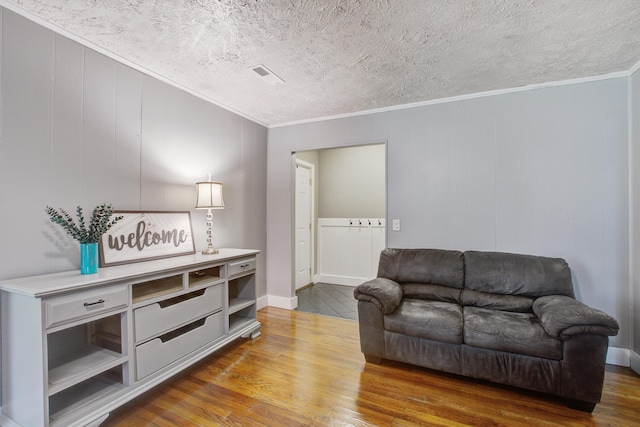 110 Terry Ave, Summerville, SC 29485 - living area with wood finished floors, crown molding, a decorative wall, and a textured ceiling