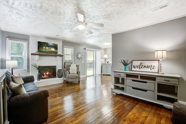 110 Terry Ave, Summerville, SC 29485 - living area with hardwood / wood-style floors, healthy amount of natural light, a textured ceiling, ceiling fan, and a brick fireplace