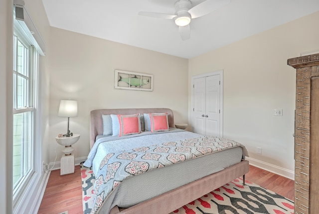 bedroom with ceiling fan, a closet, and wood-type flooring