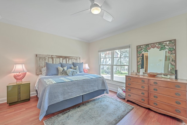 bedroom featuring ceiling fan, crown molding, and light hardwood / wood-style floors