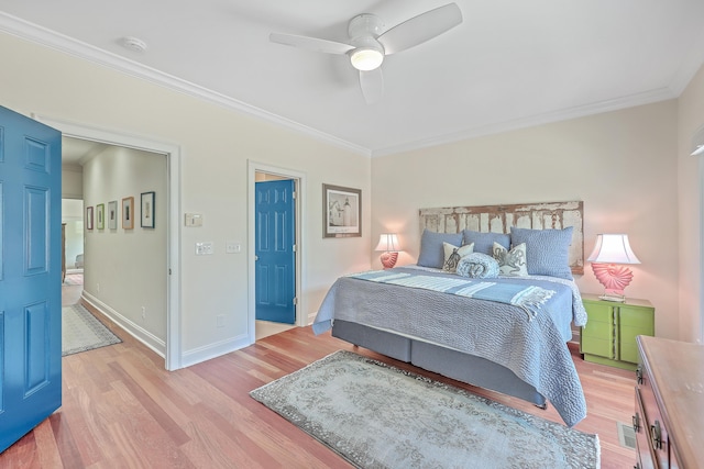 bedroom with ceiling fan, crown molding, and light hardwood / wood-style floors