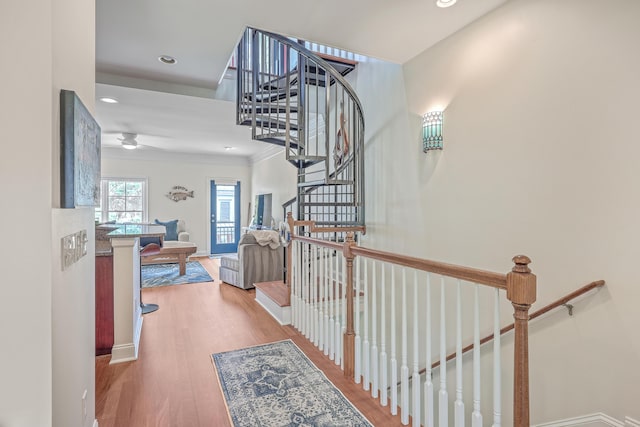 corridor featuring ornamental molding and hardwood / wood-style flooring