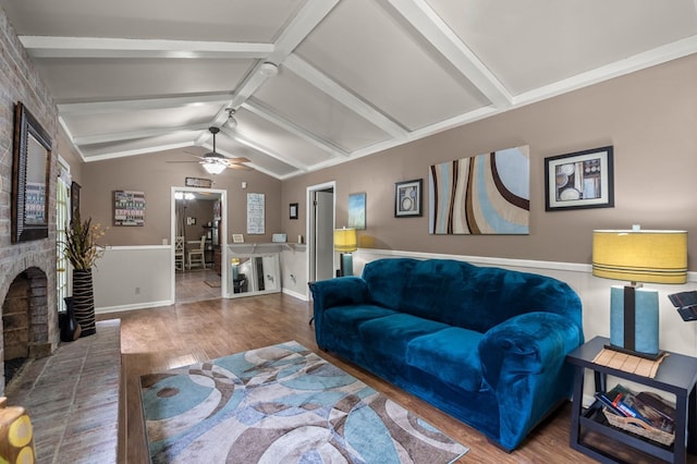 living room with lofted ceiling with beams, a fireplace, ceiling fan, and wood-type flooring