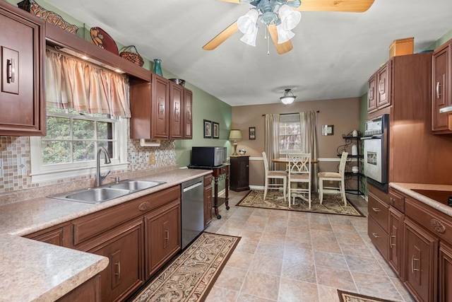 kitchen featuring a healthy amount of sunlight, oven, sink, dishwasher, and backsplash