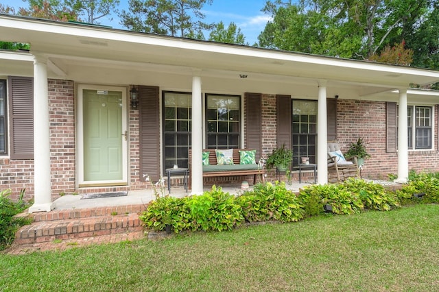 doorway to property featuring a yard and a porch