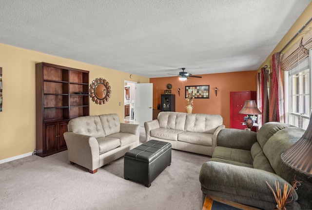 living room with light carpet, ceiling fan, and a textured ceiling