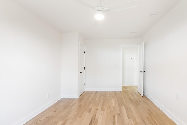 empty room with baseboards, light wood-style flooring, and a ceiling fan