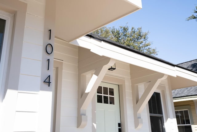 exterior details with roof with shingles