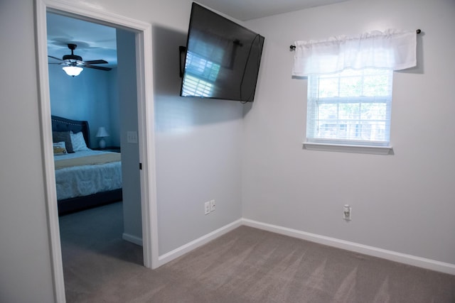 unfurnished bedroom with carpet flooring and baseboards