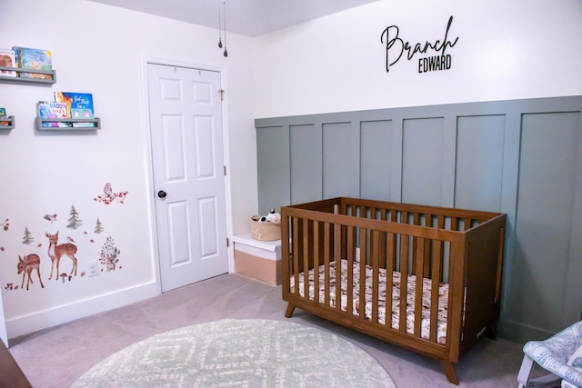 bedroom featuring carpet floors and a nursery area