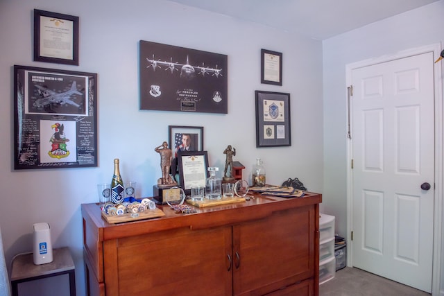 carpeted office space with a dry bar