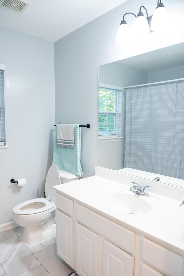 full bath with toilet, marble look tiles, vanity, and a shower with shower curtain