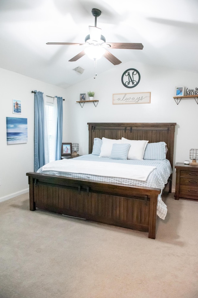 bedroom featuring light carpet, lofted ceiling, a ceiling fan, and baseboards