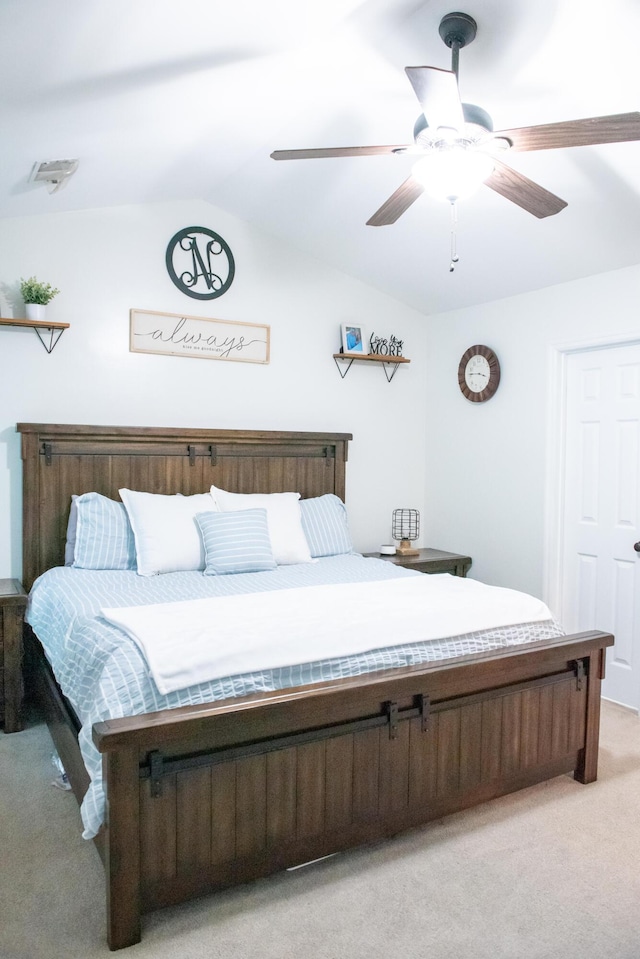 bedroom with light carpet, lofted ceiling, and ceiling fan