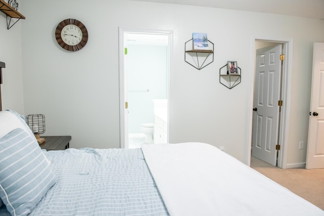 carpeted bedroom with connected bathroom