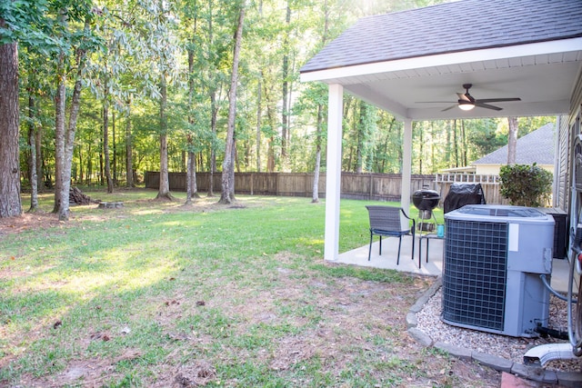 view of yard with central AC, a ceiling fan, and a patio area