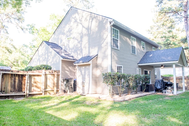 back of property featuring a ceiling fan and a patio area