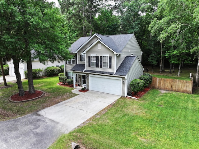 traditional-style home featuring a garage, driveway, and roof with shingles