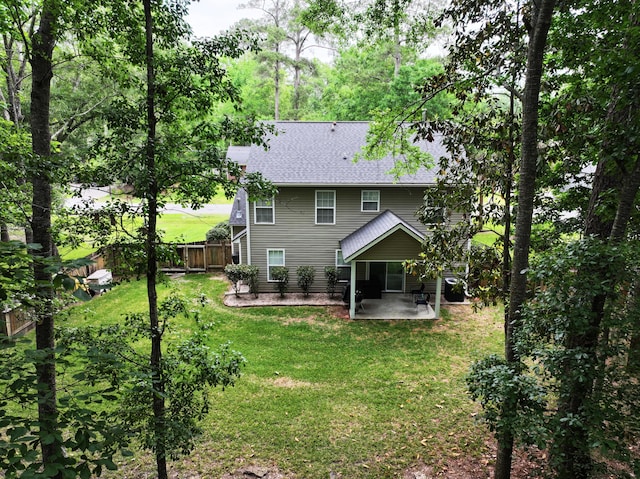 rear view of property with a patio area and a shingled roof