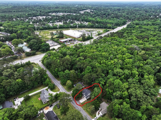 aerial view of property's location featuring a heavily wooded area