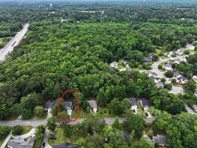 aerial view of property's location featuring a heavily wooded area