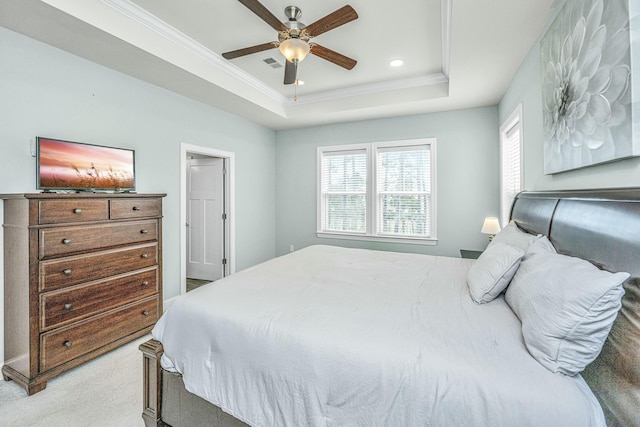 bedroom featuring crown molding, carpet, ceiling fan, and a tray ceiling