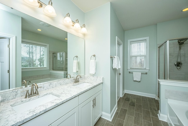 bathroom with vanity, a wealth of natural light, and shower with separate bathtub