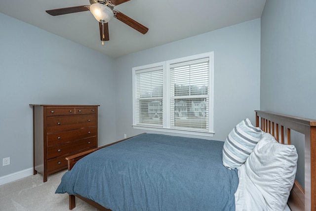 bedroom featuring ceiling fan and light carpet