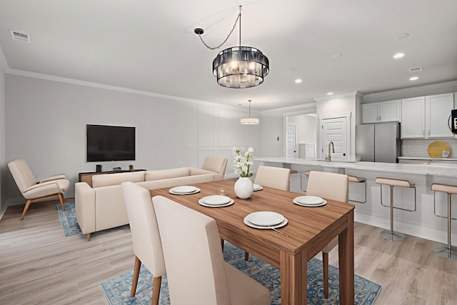 5133 Park Creek Ave, North Charleston, SC 29418 - dining room featuring crown molding, light wood-style flooring, recessed lighting, and a chandelier