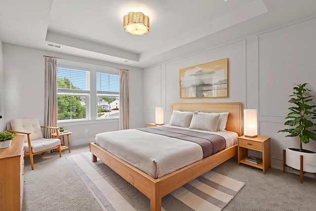 5133 Park Creek Ave, North Charleston, SC 29418 - bedroom with a tray ceiling, light carpet, and a decorative wall