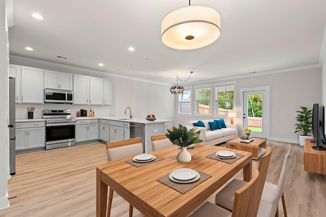 5133 Park Creek Ave, North Charleston, SC 29418 - dining room featuring crown molding, a chandelier, light wood-type flooring, and recessed lighting