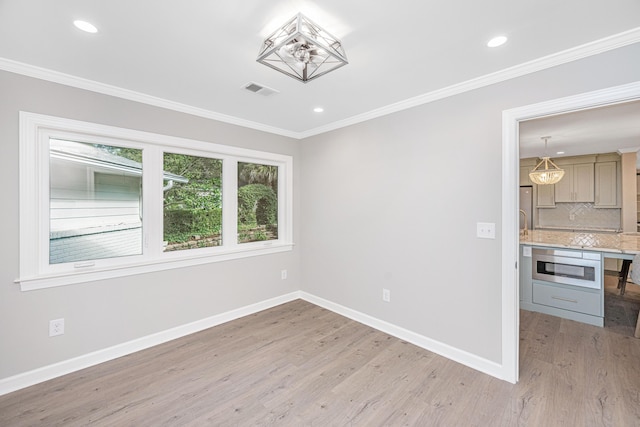 881 Evans Rd, Charleston, SC 29412 - spare room with baseboards, light wood-type flooring, crown molding, and recessed lighting