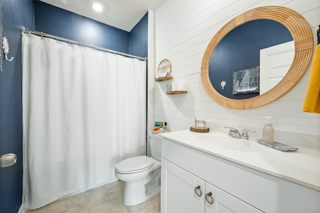 bathroom with tile patterned floors, a shower with curtain, toilet, and vanity