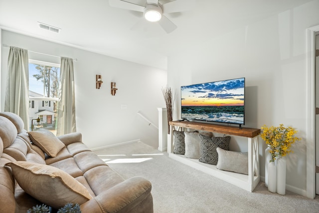 carpeted living area with a ceiling fan, visible vents, and baseboards